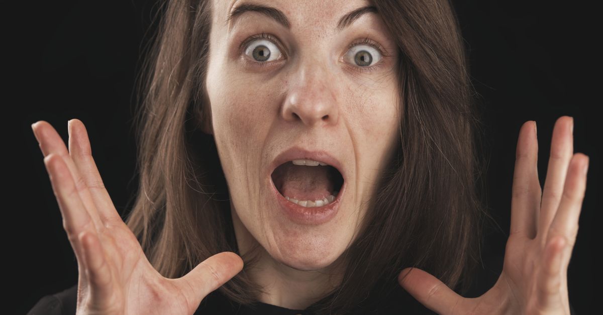 Close-up of a woman expressing shock and surprise with wide eyes and open mouth.